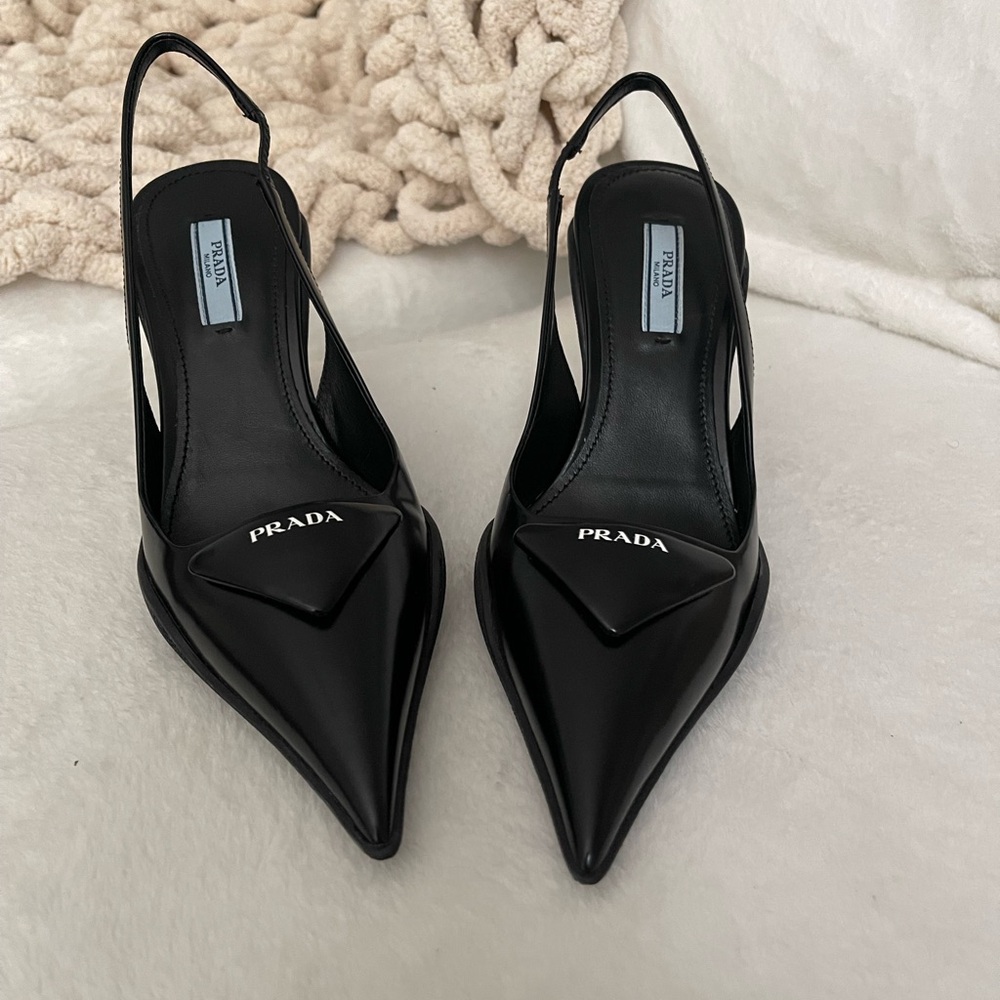 Black patent leather sling back pumps